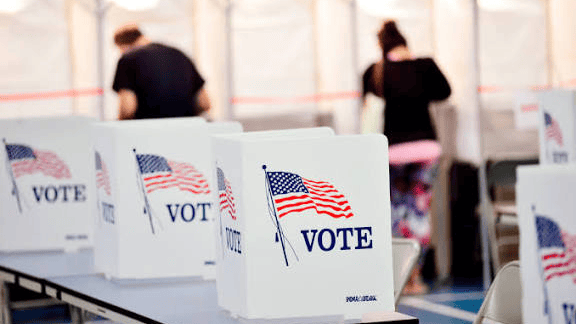 Voters cast their ballots at a polling location, illustrating the 2026 midterm elections and their potential impact on nonprofit capital planning.
